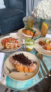 A short, aesthetic promotional video showcasing the launch of 'La Croissanterie' at Pavyllon London, featuring close-up shots of various sweet and savoury croissants and a matcha latte.