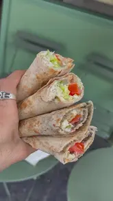 A short vlog-style video showcasing a Lebanese wrap shop in Holborn, highlighting the fresh preparation of wraps and bowls.