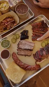 A review of Fort Smokehouse in Norbury, featuring a variety of smoked meats including brisket, pastrami, lamb ribs, and sausages, along with sides like mac and cheese and beans. The creator provides a taste test and rating for each item.