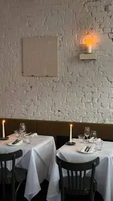 A short, atmospheric montage showcasing the interior and food at Vesper restaurant in Exmouth Market, London. The video features shots of candlelit tables, a burger, and a mortadella dish, highlighting the venue's aesthetic and walk-in availability.