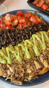 A review of Notella Bites in Falkirk, showcasing their dessert menu including waffles, pancakes, and drinks, with a focus on the pink-themed interior.