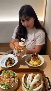 A short vlog-style video showcasing a visit to Belly Bliss in London's Chinatown, highlighting their cute corgi-themed shaved ice desserts and chicken katsu omurice curry.