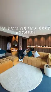 A travel vlog showcasing a luxury suite near Oban, Scotland, highlighting the room's amenities, the private hot tub, and local food experiences including fish and chips and fresh seafood.