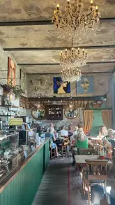 A short, engaging reel showcasing The Reading Room in Brighton, highlighting its book-themed interior, outdoor seating, and lunch options like burrata salad and matcha lattes.