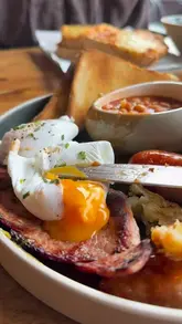 The creator visits Valerie's Coffee, a cafe located inside the Tony Almond garden centre in Waterloo. The video features a tour of the retail space followed by a review of several menu items, including a Full English breakfast, a Croque Monsieur, a chicken Caesar salad, and various cakes.
