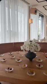 A montage of interior shots of Lunette in London, showcasing the restaurant's decor, kitchen, and views of the London skyline, alongside small plates from a tasting menu.