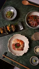 A high-quality, cinematic montage showcasing three new limited-edition donburi bowls at The Fuji Grill. The video features close-up shots of food preparation, including blow-torching, plating, and garnishing, highlighting ingredients like wagyu, caviar, sashimi, and miso-glazed aubergine.