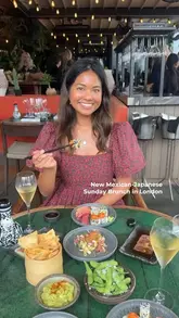A vibrant showcase of a Mexican-Japanese Sunday brunch experience at Los Mochis City, featuring a wide array of sushi, sashimi, ceviche, and robata dishes, alongside live music and a luxury trunk show.