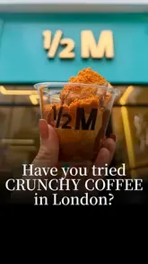 A short, high-energy video showcasing the assembly of a 'Crunchy Coffee' dessert at Half Million in London, featuring vanilla ice cream, espresso, Nutella, Biscoff sauce, and Biscoff crumb.