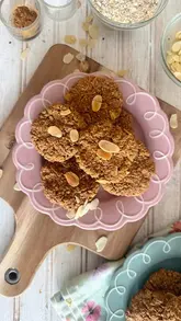 A top-down recipe tutorial demonstrating how to make vegan and gluten-free oat and almond cookies, featuring Pyrex bakeware.