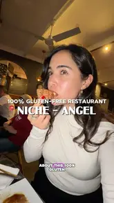 A creator visits Niche, a 100% gluten-free restaurant in Angel, London, showcasing a variety of dishes including fried chicken, mac and cheese, and focaccia, while highlighting the ease of dining out with coeliac disease.