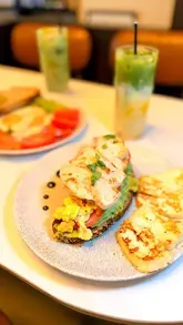 A short video showcasing a visit to Amelia's in Covent Garden, featuring the cafe's interior, a selection of pastries, iced matcha drinks, and brunch dishes like avocado toast with chicken and eggs.