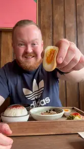 A creator visits 'Lonely Mouth' in Bristol, a Japanese listening cafe, to support the business. He reviews the Japanese Teishoku breakfast (with salted salmon, pickles, miso soup, rice, and egg) and the matcha French toast, highlighting the unique concept and quality of the food.