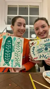 A vlog-style video showcasing a 'Painting and Pinot' workshop at April 11 in Durham. The video features two friends participating in the activity, enjoying wine and a cheese board, and highlighting the relaxed, creative atmosphere of the venue.