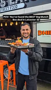 A high-energy, vlog-style review of a vegetarian 'Munch Box' from Dhil's Veg Street Food in Leicester, showcasing the variety of items included in the deal and the preparation process.