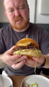A couple visits 'Beyond the Break' in Croyde, reviewing their experience and a variety of dishes including small plates, loaded fries, and a double smash burger. The video features a tour of the venue and honest feedback on the food quality.