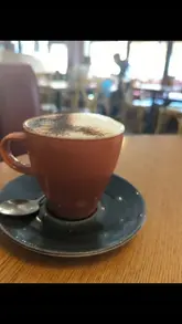 A montage of clips showcasing the interior, menu, and food offerings at Baker Street Kitchen, including sourdough with eggs and halloumi, pancakes, and drinks.