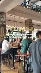 A promotional reel for All Bar One's 'Throwback Bottomless Brunch,' featuring two women enjoying cocktails, prosecco, and brunch dishes in a 90s-themed setting.