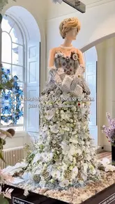 A video showcasing the 'Fleurs de Villes DIANA' floral exhibition at Somerset House in London, featuring mannequins dressed in outfits made entirely of fresh flowers, each representing a significant moment or aspect of Princess Diana's life.