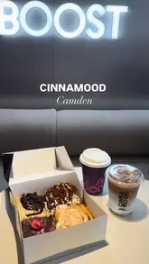 A promotional reel for Cinnamood in Camden, showcasing a wide selection of flavoured cinnamon rolls, matcha drinks, and coffee. The video features close-up shots of the pastries being pulled apart and a quick tour of the shop's interior and merchandise.