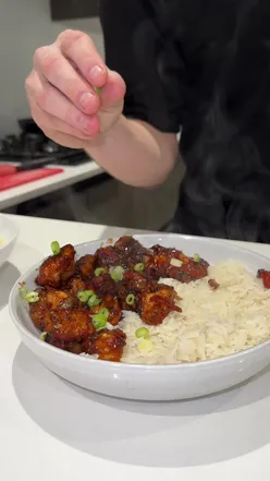 Delicious Honey Chilli Chicken with soy sauce, honey, and sriracha, air-fried and served with rice and spring onions.