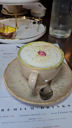 Pistachio latte from Royâ Glasgow's afternoon tea menu, launching Feb 7th. Perfect blend of coffee and pistachio flavors.