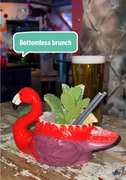 Colorful cocktails and mini pizzas at a boozy brunch in Cuckoo, Leeds, perfect for a fun night out.