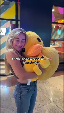 Guests enjoying burgers and cocktails at Fayre Play launch in Newcastle, showcasing fun games and delicious food.