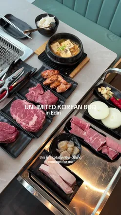 Guests enjoying Korean BBQ at Wuji Asian Circle in Edinburgh, experiencing unique DIY dining with flavorful meats.