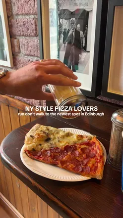 New York style pizza slices at Sears Pizza in Marchmont, Edinburgh, perfect for pizza lovers.