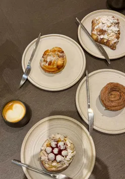 Enjoying pastries and coffee at Saint Hugo Bakery in Swansea, the perfect morning spot for food lovers.