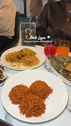 Guests enjoying Nigerian dishes like Jollof rice and Beef Suya at the lively @midelagos_ opening in Birmingham.