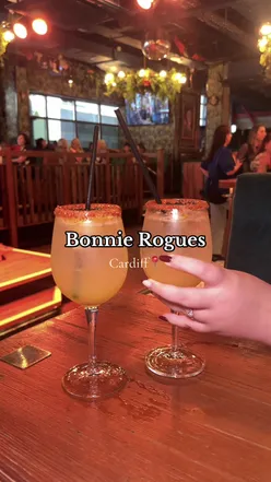 Guests enjoying classic cocktails at Bonnie Rogues in Cardiff, featuring an espresso martini and vibrant nightlife ambiance.