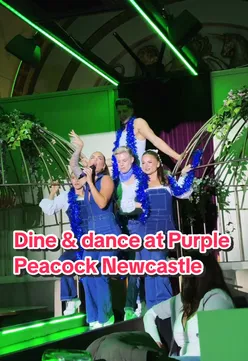 Guests enjoying a vibrant dining and interactive theater experience at The Purple Peacock in Newcastle, featuring live performances.