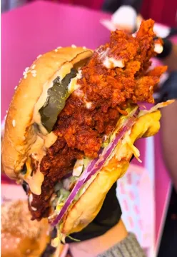 Busy Chicka restaurant in Birmingham serving flavorful Nashville tenders and burgers, showcasing the vibrant food scene.