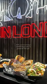Delicious beef burger with loaded fries at a popular London eatery, inviting return visits for more tasty meals.