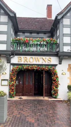 Couple enjoying a romantic meal at Browns in Sutton Park, Birmingham, featuring delicious dishes like fillet steak and tiramisu.