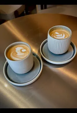 Stunning interiors at Kloud Concept in Glasgow, featuring fresh yogurt bowls, coffee, and a sleek nighttime bar vibe.