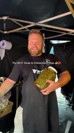 Delicious steak pitta with cheese and chimichurri from HighSteaks at a Bristol food market, enjoyed by two friends.