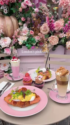 Exterior of Peggy Porschen café in Belgravia, featuring pink decor, seasonal decorations, and a cozy atmosphere.