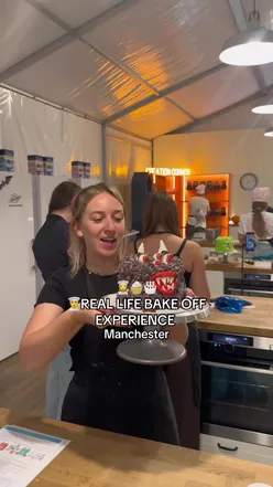 Participants enjoying a Halloween-themed bake-off experience in Manchester, creating cakes in pairs.