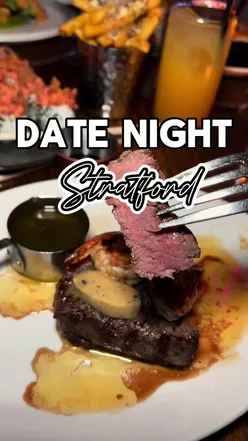 Couple enjoying a romantic dinner at STK Stratford, featuring stylish decor and stunning city views.