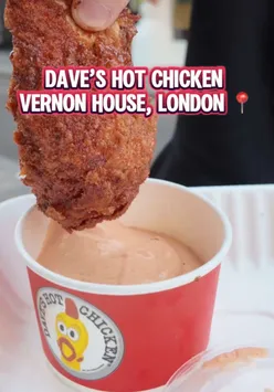 Delicious fried chicken meal from Dave's Hot Chicken on Shaftesbury Ave, London, featuring spicy wings and sides.