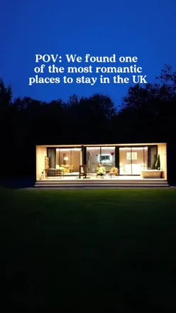 Couple enjoying a romantic stay at Midnight Moon Lodge in Somerset with stunning views and luxurious amenities.