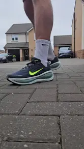 Person wearing Nike Vonero Plus Hoodie and Montirex Dublin Vest, enjoying a run in athletic shorts, promoting fitness lifestyle.