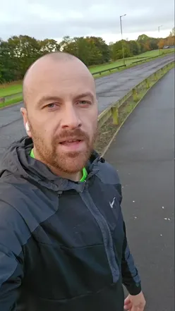 Excited runner celebrating after completing their first half marathon, showcasing health and fitness enthusiasm.