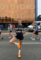 Runner celebrating a personal best time with PUMA shoes at a race event, grateful to SportsShoes for the opportunity.