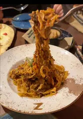 Delicious Italian dishes at Zizzi Winchester: pizza, pasta, and refreshing drinks in a stunning restaurant setting.