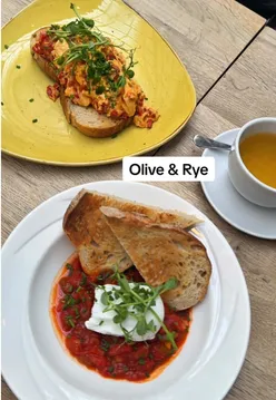 Brunch spread featuring coffee, eggs, and pastries at Olive & Rye in Leeds, perfect for a cozy meal outing.