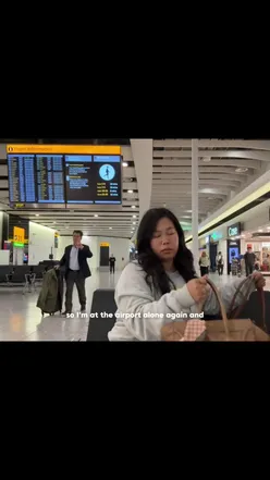 Travel blogger at airport, excitedly flying from London to Aruba for Restaurant Week culinary festival.